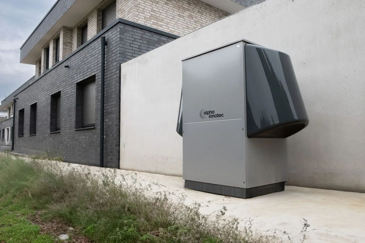 Illustrative category photo of a heat pump installed beside a building